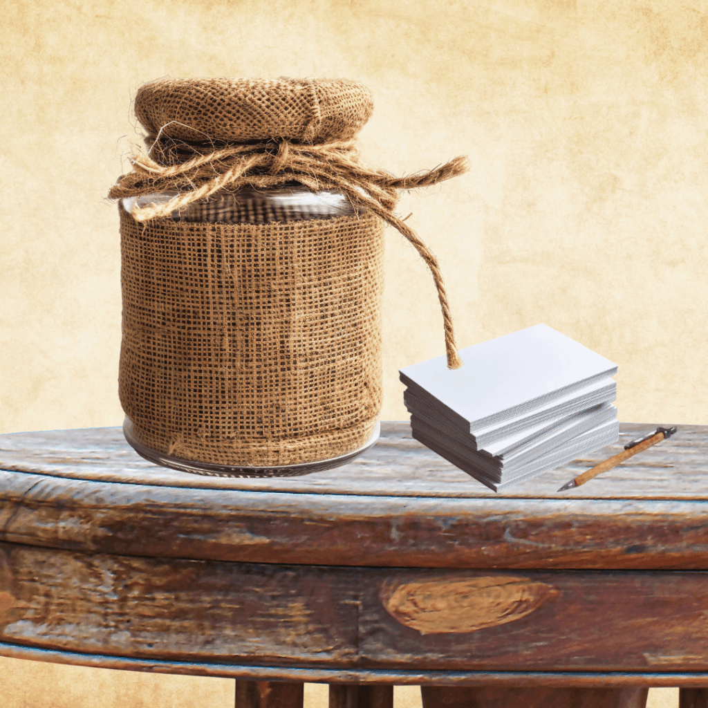 Thankful jar on rustic wooden table with notes and pen